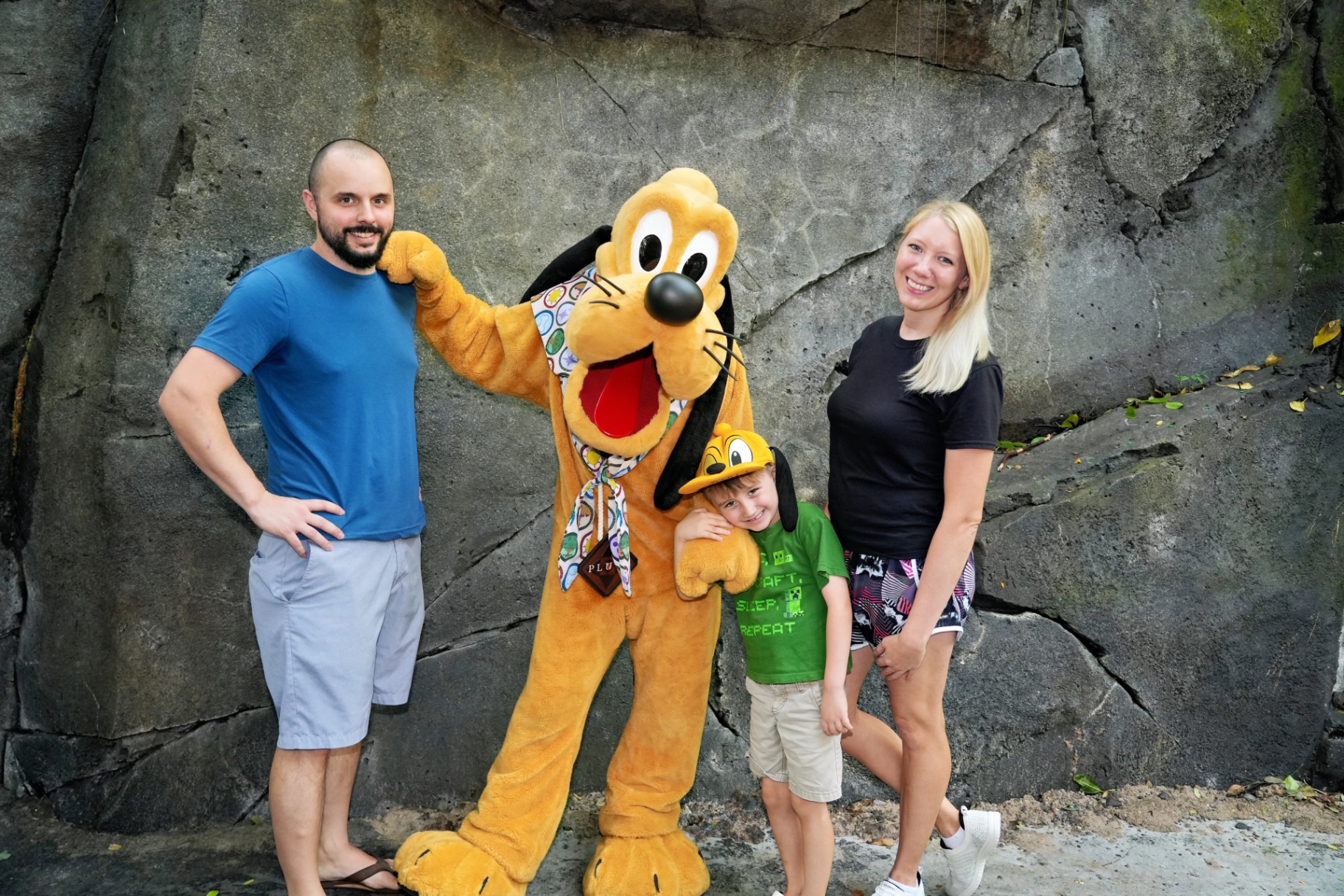 Dalton and his family with Pluto at Disney